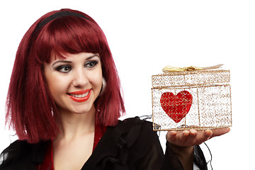 Image showing Happy girl with heart in a golden gift box