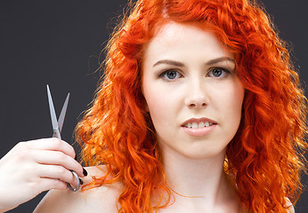 Image showing redhead with scissors