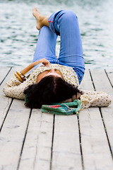 Image showing woman lying near the river
