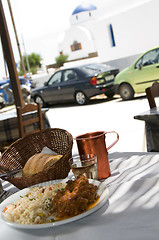 Image showing lunch of greek island taverna specialty lamb with greek church i