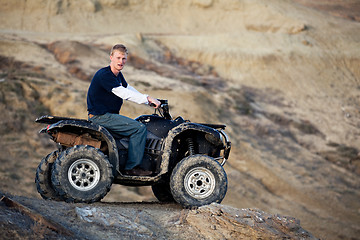 Image showing teen on quad ATV in the hills