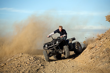 Image showing teen riding quad ATV in hills