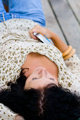 Image showing woman lying with book