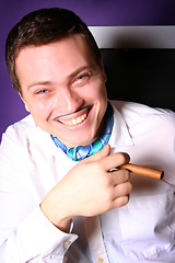 Image showing Portrait of a smiling man holding cigar