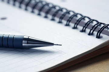 Image showing Close up of a pen on a note pad