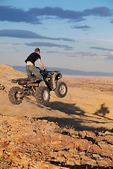 Image showing Teen jumping on quad ATV