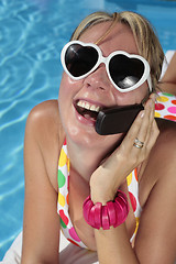 Image showing Woman on her Cellphone by the Pool