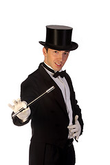 Image showing young magician performing with wand 