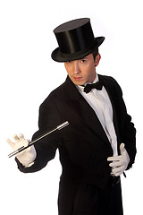 Image showing young magician performing with wand 