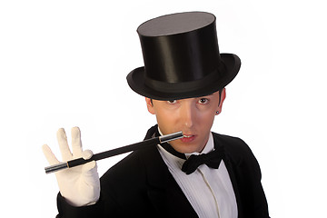 Image showing young magician performing with wand 