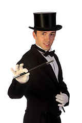 Image showing young magician performing with wand 