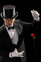 Image showing young magician performing red rose