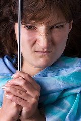 Image showing frowning woman in blue headscarf