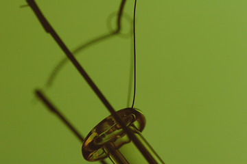 Image showing light bulb filament on green background