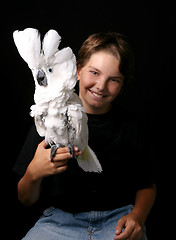 Image showing Young Child Holding an Excited Umbrella Cockatoo