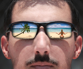 Image showing Man Looking at a Woman on the Beach Through Sunglasses