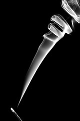 Image showing Stick with a white smoke. Isolated on black