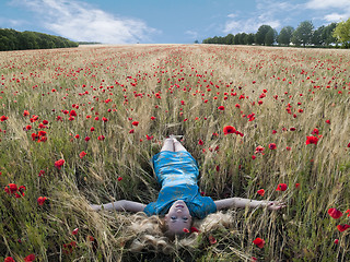 Image showing Blonde in poppies