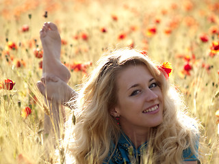 Image showing Barefoot blonde in poppies