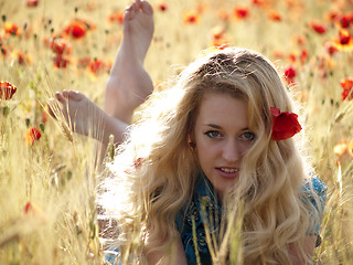 Image showing Barefoot blonde in poppies