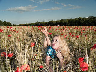 Image showing Blonde in poppies