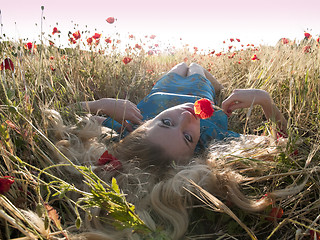 Image showing Blonde in poppies