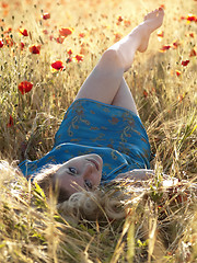 Image showing Barefoot blonde in poppies