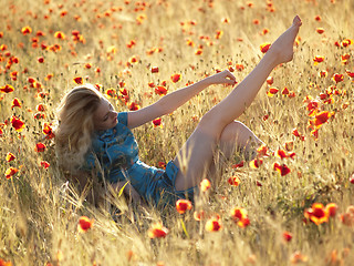 Image showing Barefoot blonde in poppies