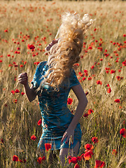 Image showing Blonde in poppy field