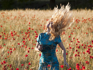 Image showing Blonde in poppy field