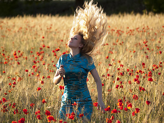 Image showing Blonde in poppy field