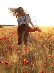 Image showing Blonde walking in poppy field