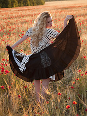 Image showing Blonde walking in poppy field