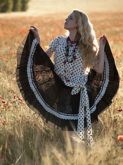 Image showing Blonde walking in poppy field