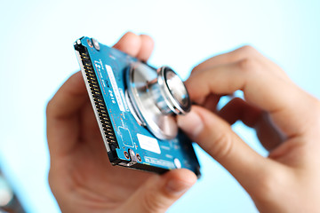 Image showing Doctor holding stethoscope at notebook hdd