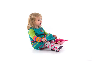 Image showing Happy baby sitting on the floor