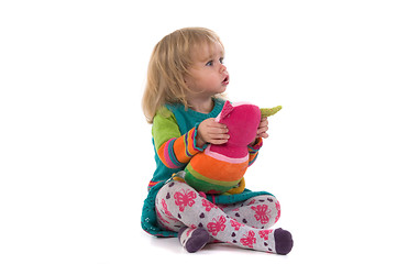 Image showing Baby with toy sitting on the floor