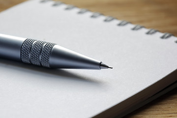 Image showing Close up of a pen on a note pad