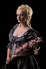 Image showing Beautiful woman with flowers on black background