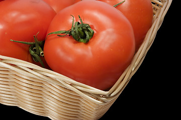 Image showing Basket with tomatoes on black background with clipping path