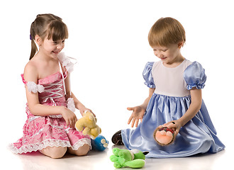 Image showing Two girls playing with toys on the floor