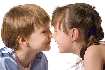 Image showing Two smiling little girls sit face to face