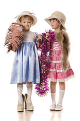 Image showing Two little girls with tinsel, feather and fur