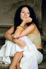 Image showing attractive woman sitting on wooden stairs