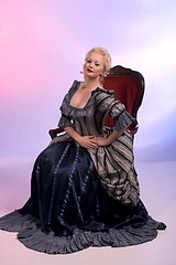 Image showing Beautiful woman sitting on a chair