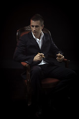 Image showing Handsome young man smoking cigar