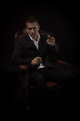 Image showing Handsome young successful businessman smoking a cigar