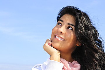 Image showing Beautiful young woman looking up