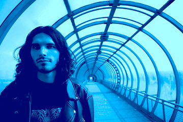 Image showing long-haired men in blue tunnel