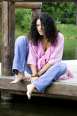 Image showing  woman sitting near the water